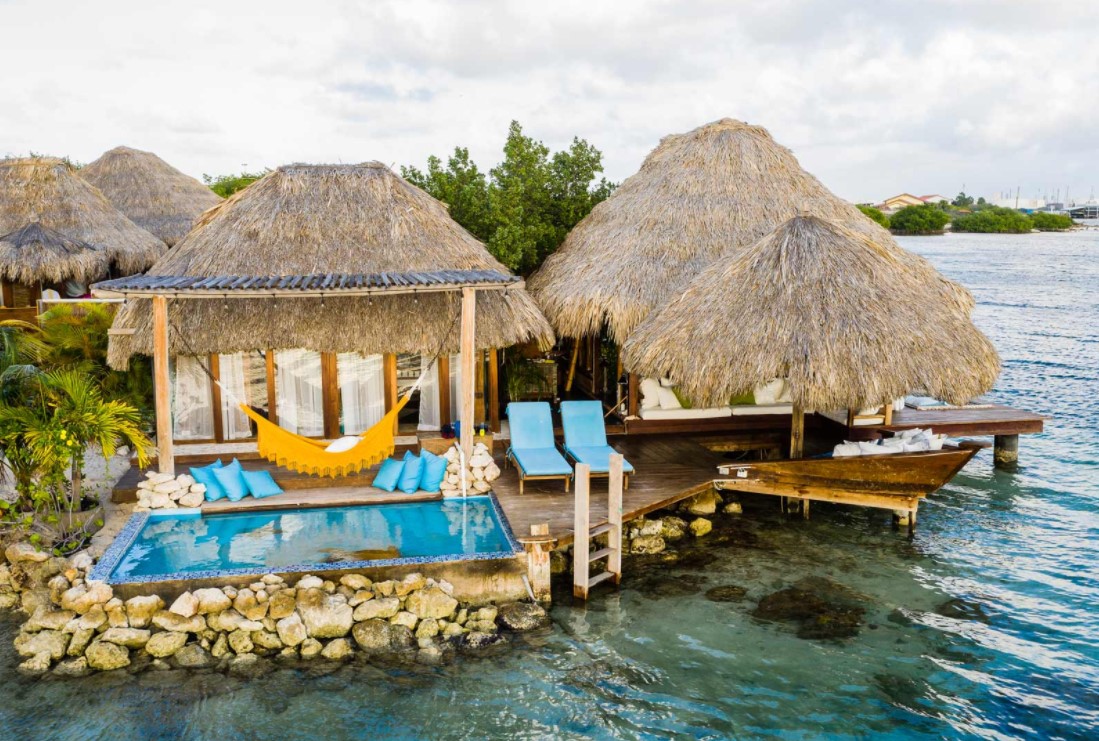 An arial view of a luxury overwater bungalow near the usa with its own private plunge pool, lounging area, and ocean views