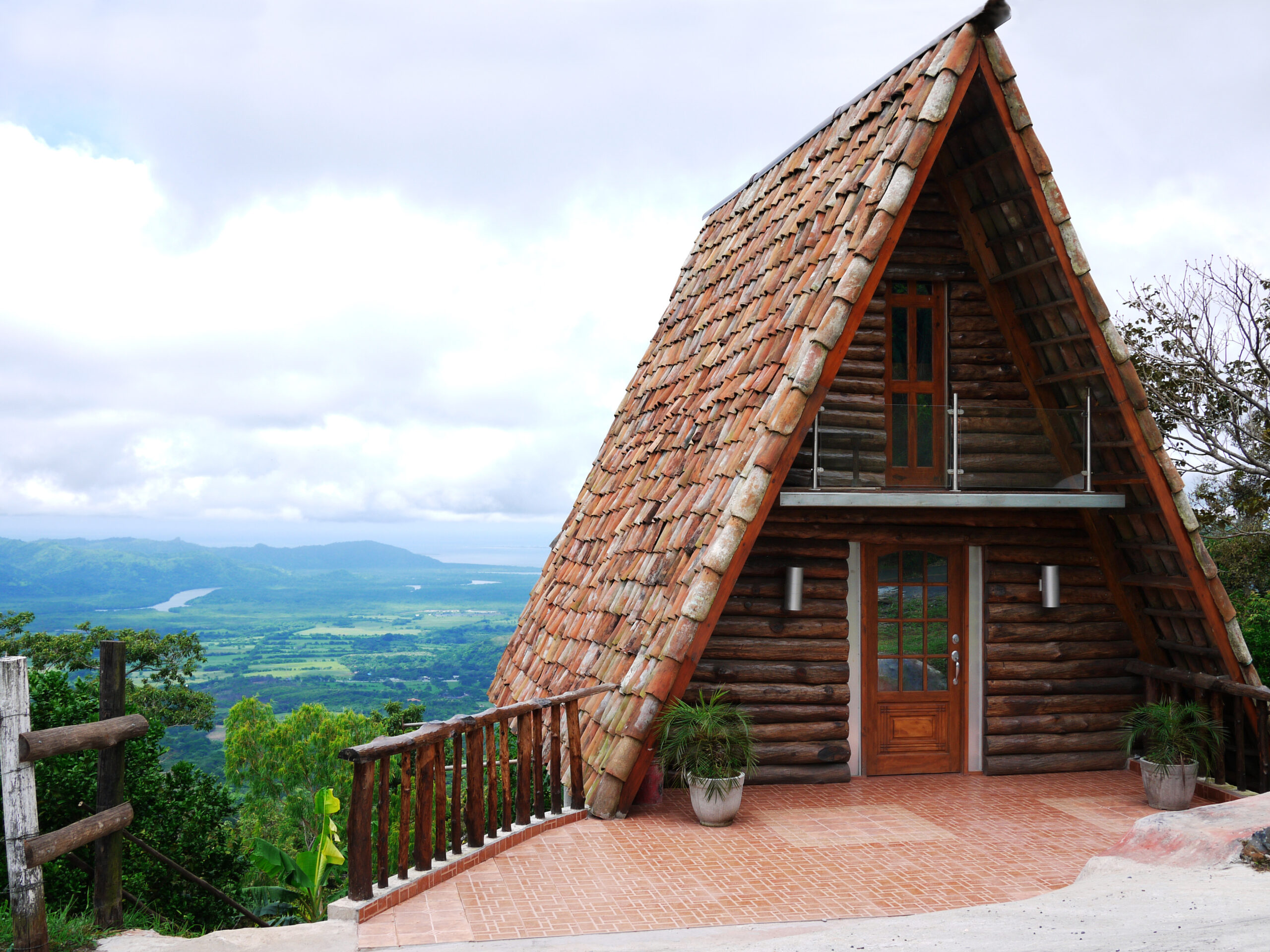 A frame cabin with a background of hills and mountans. One of the best cabins in Oregon.