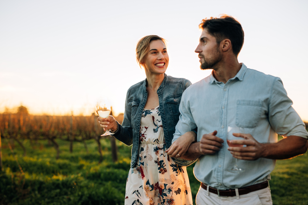 A couple enjoying wine at a vineyard