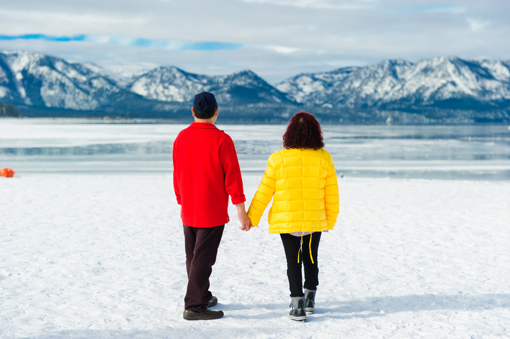 A couple looking out at Lake Tahoe in the winter