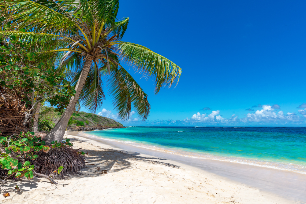 Beautiful beach with white sand and crystal blue waters in Puerto Rico one of the best honeymoons in the usa