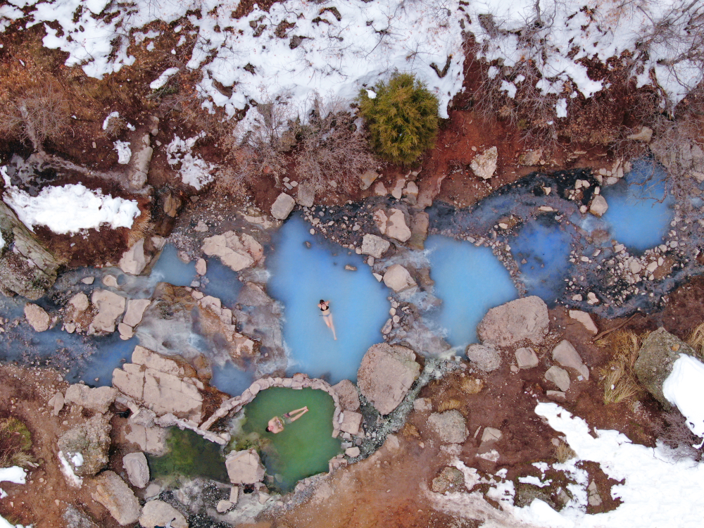 An overhead image of people bathing in the Diamond Fork Hot Springs one of the best hikes in the usa