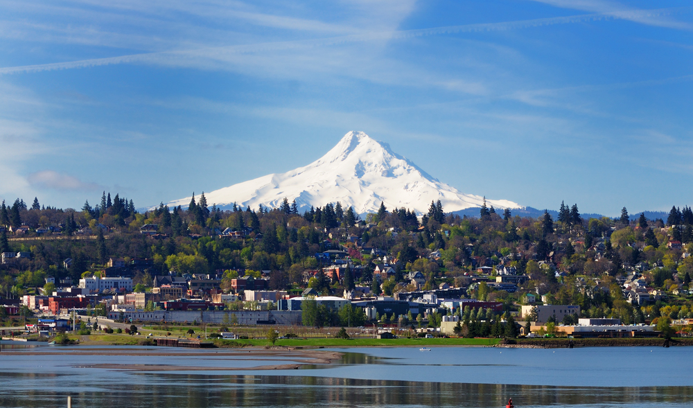 A view of Hood River from the water with Mt. Hood looming behind it.