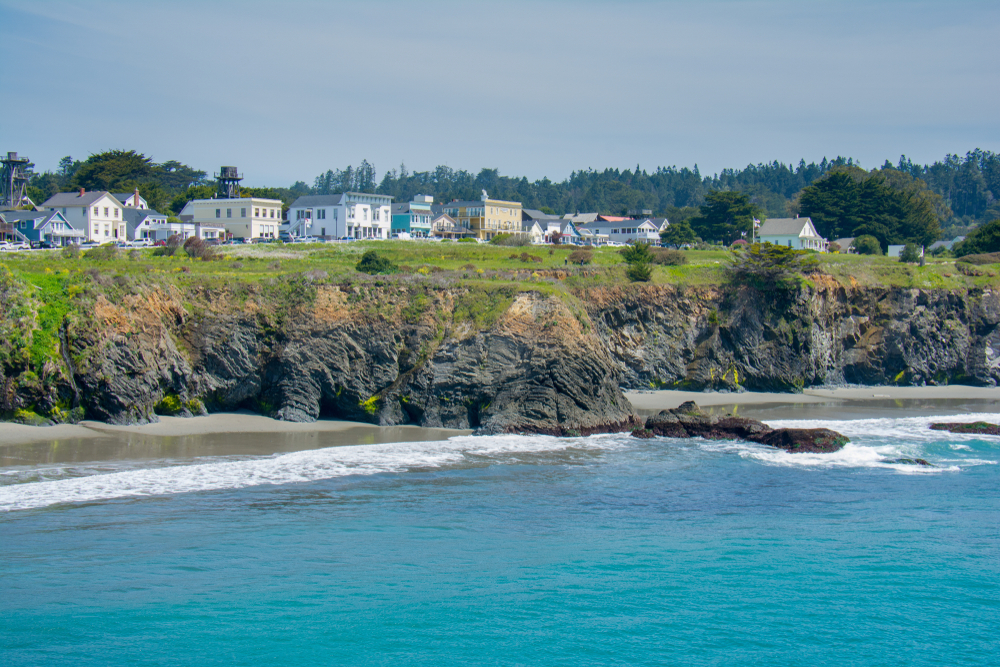 View of Mendocino California from the water looking at the cliffs and houses, one of the cutest small towns on the West Coast