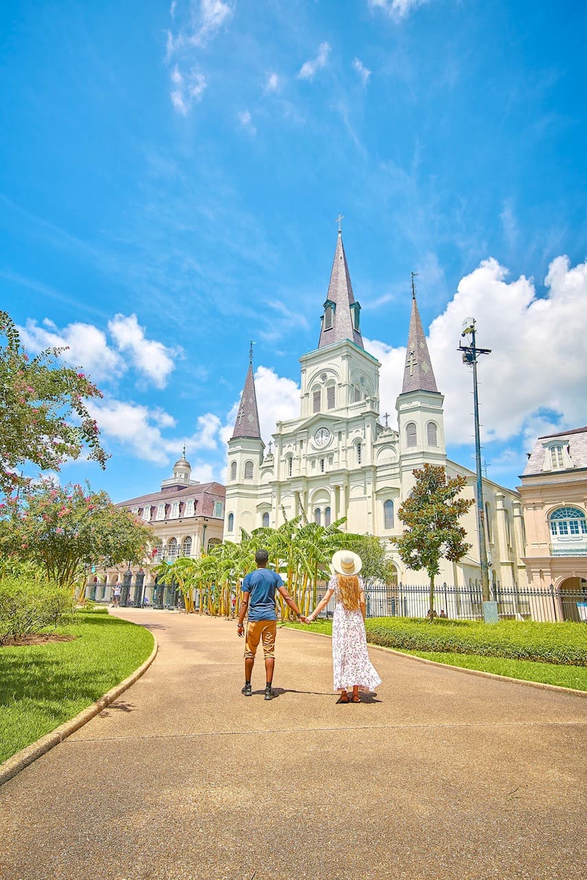 A couple holding hands outside of Jackson Square in New Orleans one of the best honeymoon destinations in the usa