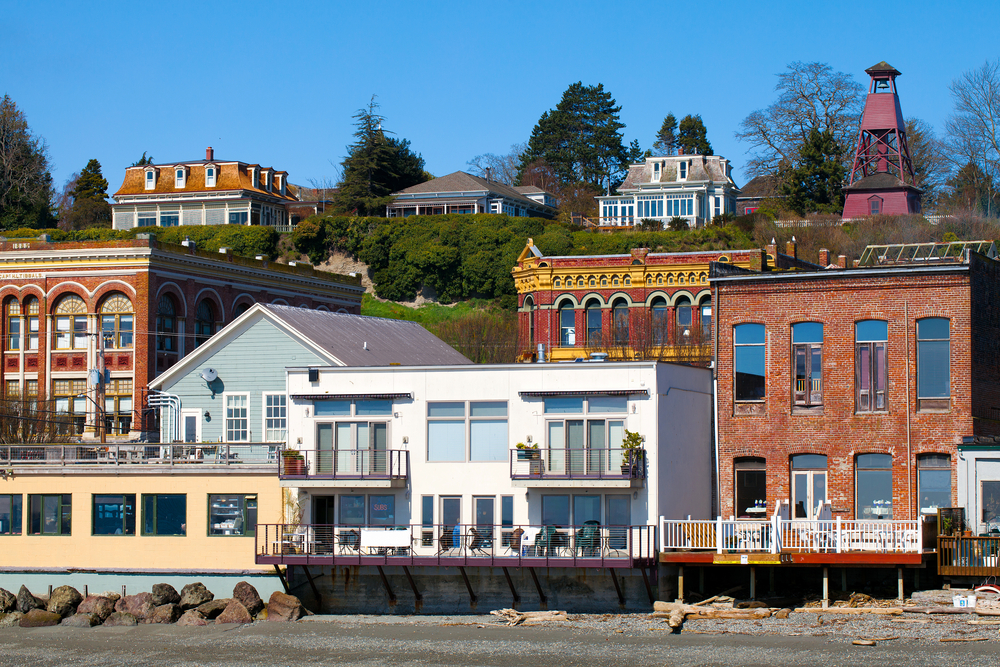 The view of shops and buildings directly on the beach in Port Townsend Washington, one of the cutest small towns on the West Coast