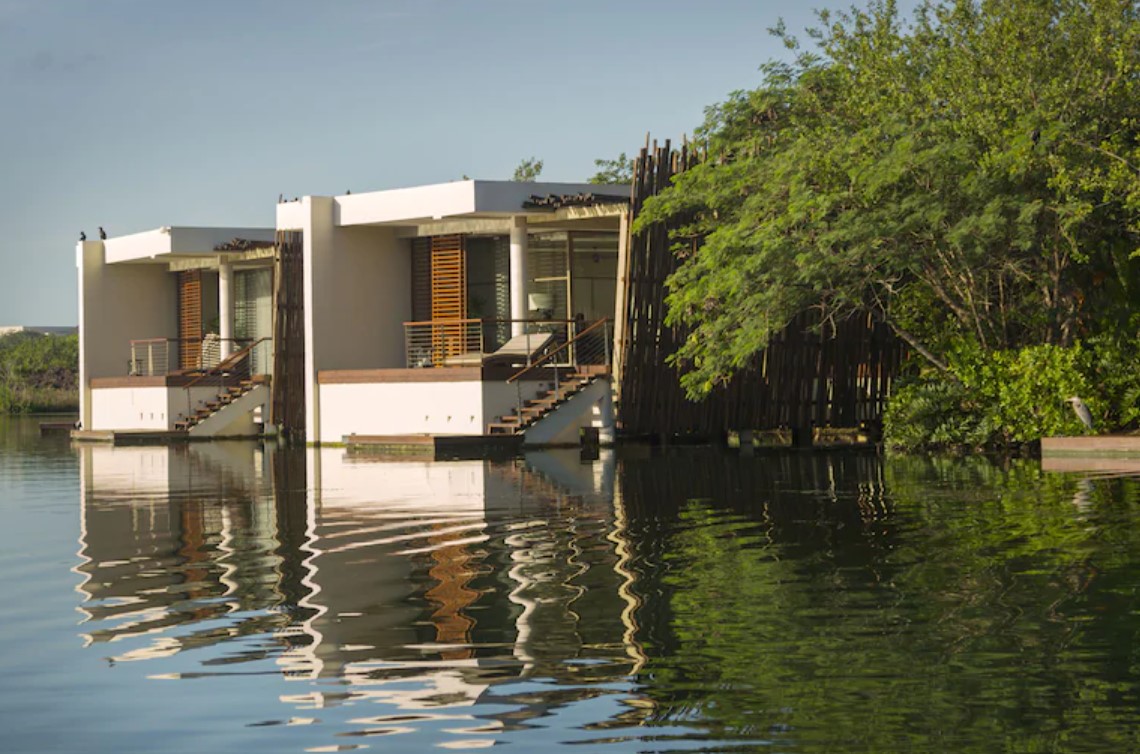 The otuside of two overwater bungalows near the usa that sit in a Mexico lagoon