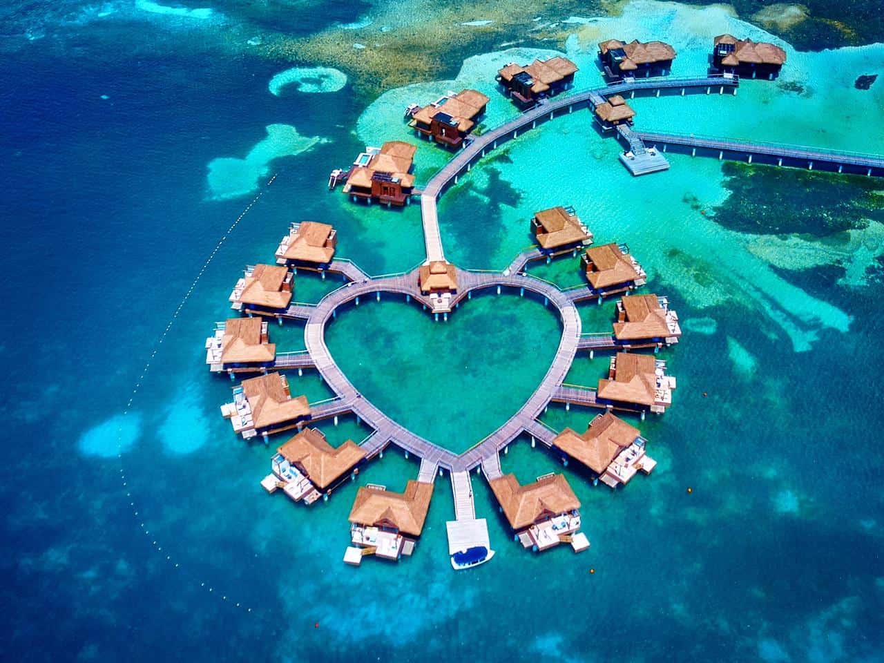 Arial photo of overwater bungalows near the usa arranged in the shape of a heart