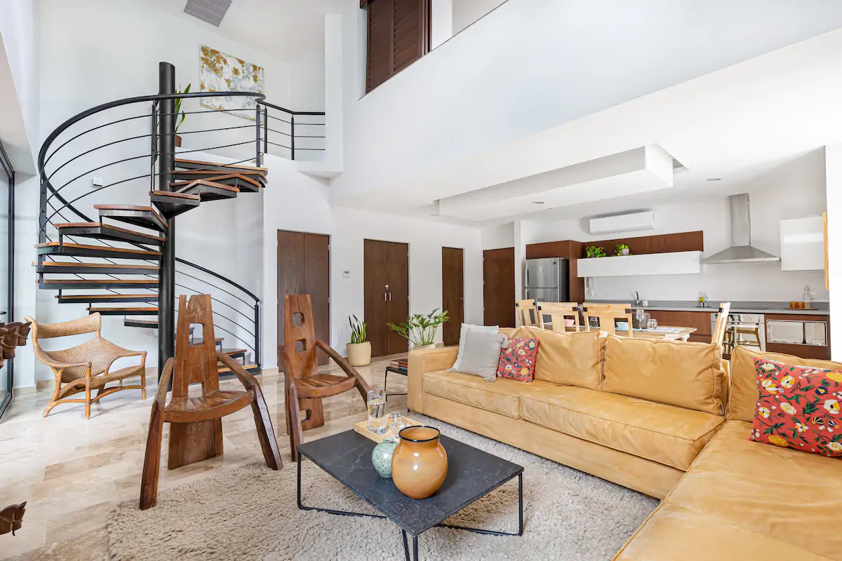 This luxury apartment with a spiral staircase and epic sectional sofa is one of the best Airbnbs in Cancun.