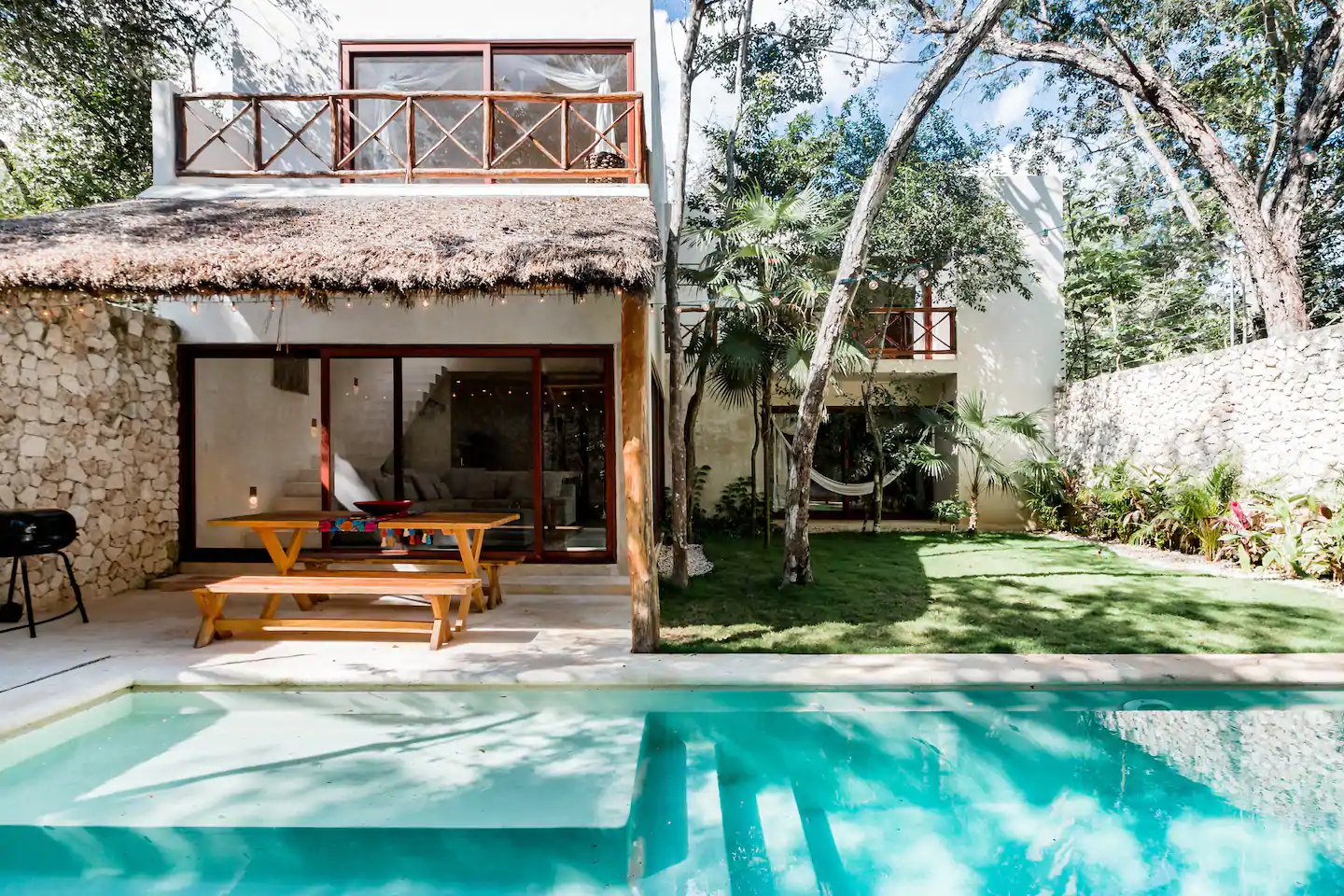 This is one of the best Airbnbs resorts in Tulum. The pool looks so clean and there is a picnic table, BBQ, and hammock visible. 