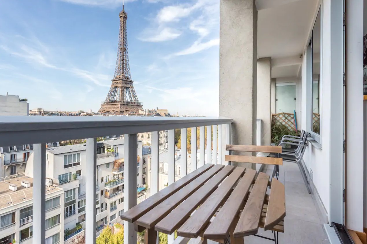 The view of the Eiffel Tower on a small private balcony in a studio apartment in Paris