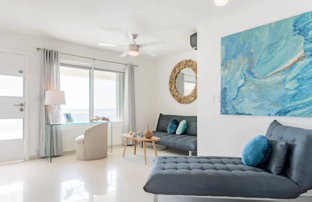 The sitting area of a bright an airy penthouse on the coast in Cancun