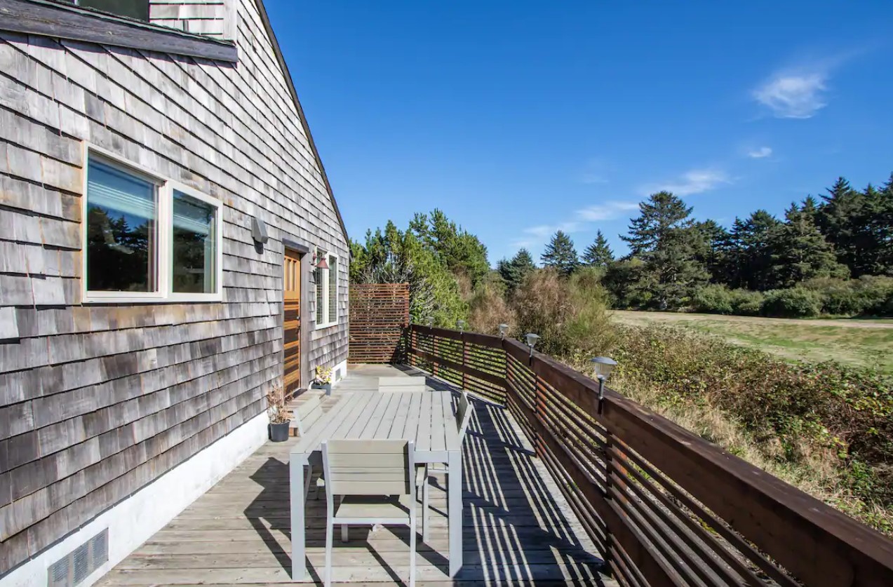 The private front deck of a beachside guest house in Seaside Oregon one of the best Oregon Coast Airbnbs