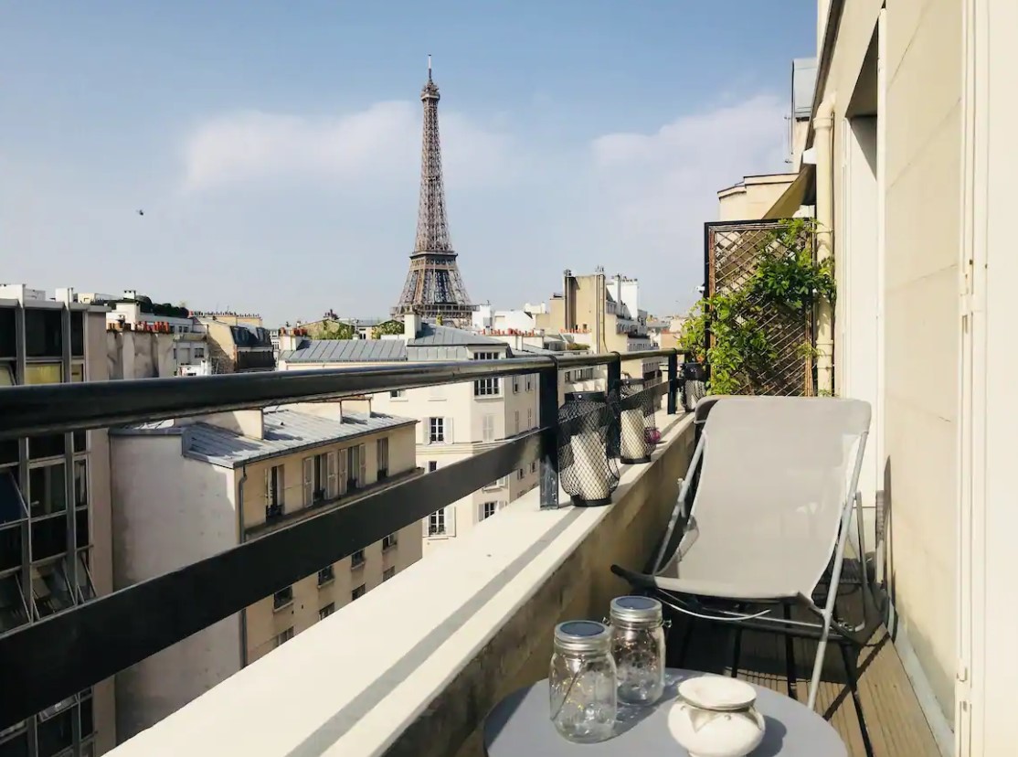 The view of the Eiffel Tower from a private terrace in a small apartment in Paris that also has views of the Paris cityscape