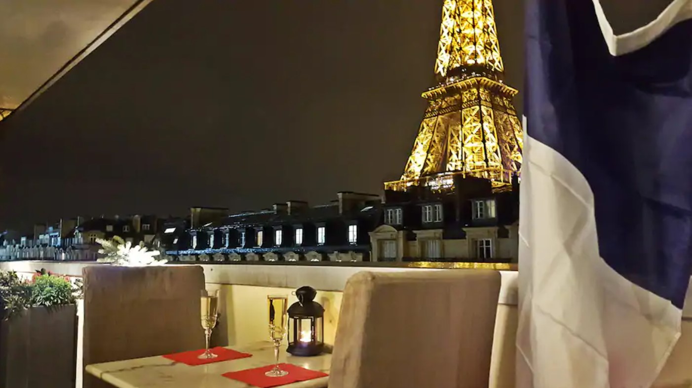 The view of the Eiffel Tower at night from the private balcony in a building at the base of the Eiffel Tower