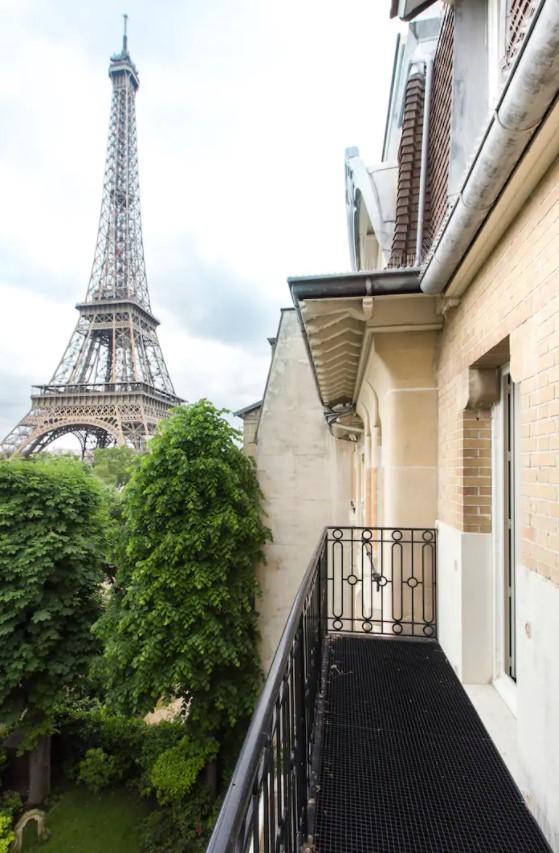 The view almost looking straight up the Eiffel Tower from a small balcony in a large apartment near the Eiffel Tower in Paris