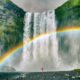 An article about rainbow quotes featuring a girl standing in front of a waterfall.