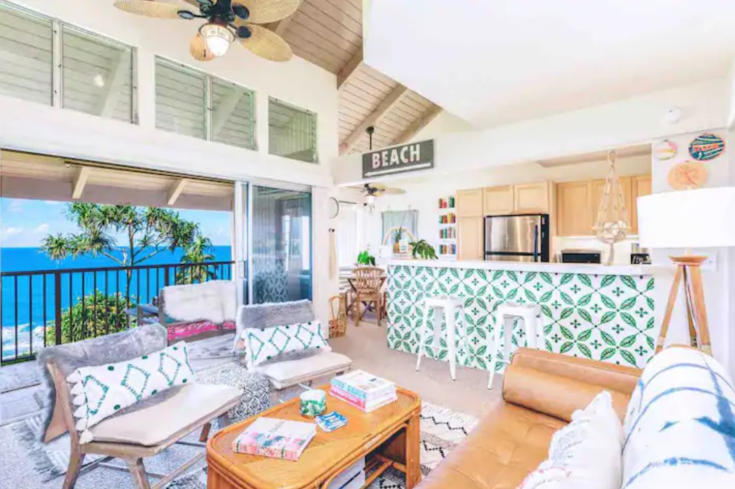 The interior view of a condo with views of the pacific ocean and eclectic boho decorations in Kauai Hawaii