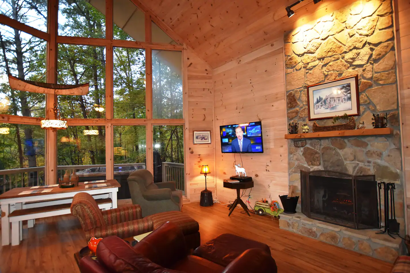 cozy living room with floor to ceiling windows and tree view