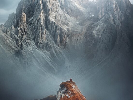 woman standing on top of mountain in italy