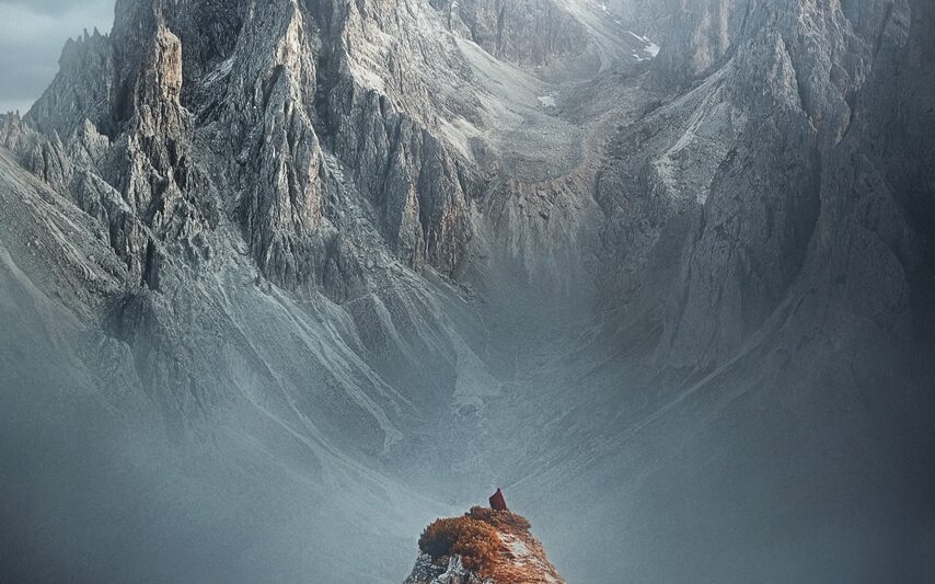 woman standing on top of mountain in italy