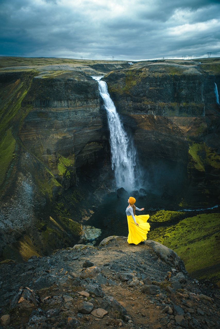 wilderness quotes. woman on a ledge with waterfall in background