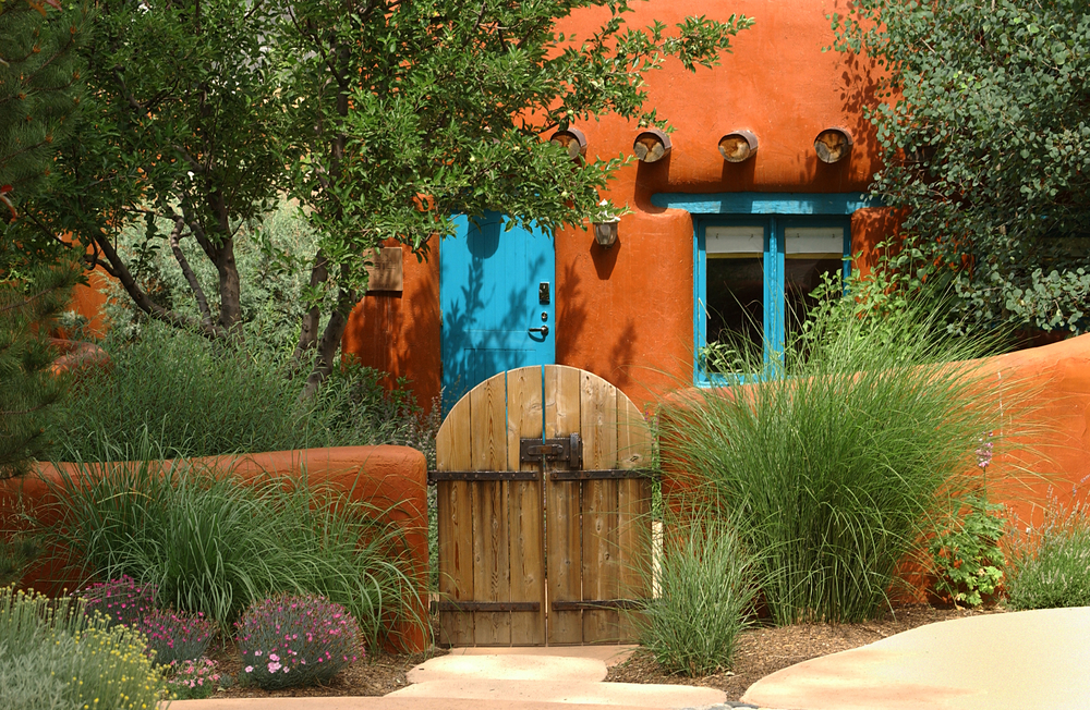 an orange adobe home in the same style of many of the best Airbnbs in Santa Fe