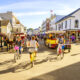 people biking on the streets of Mackinac Island one of the best small town beaches in the usa