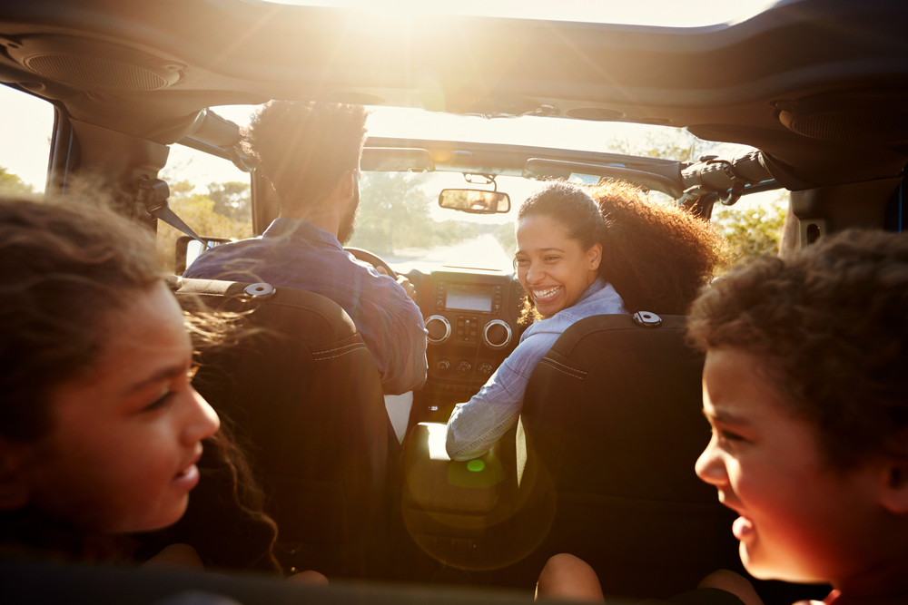 A family in the car asking road trip questions