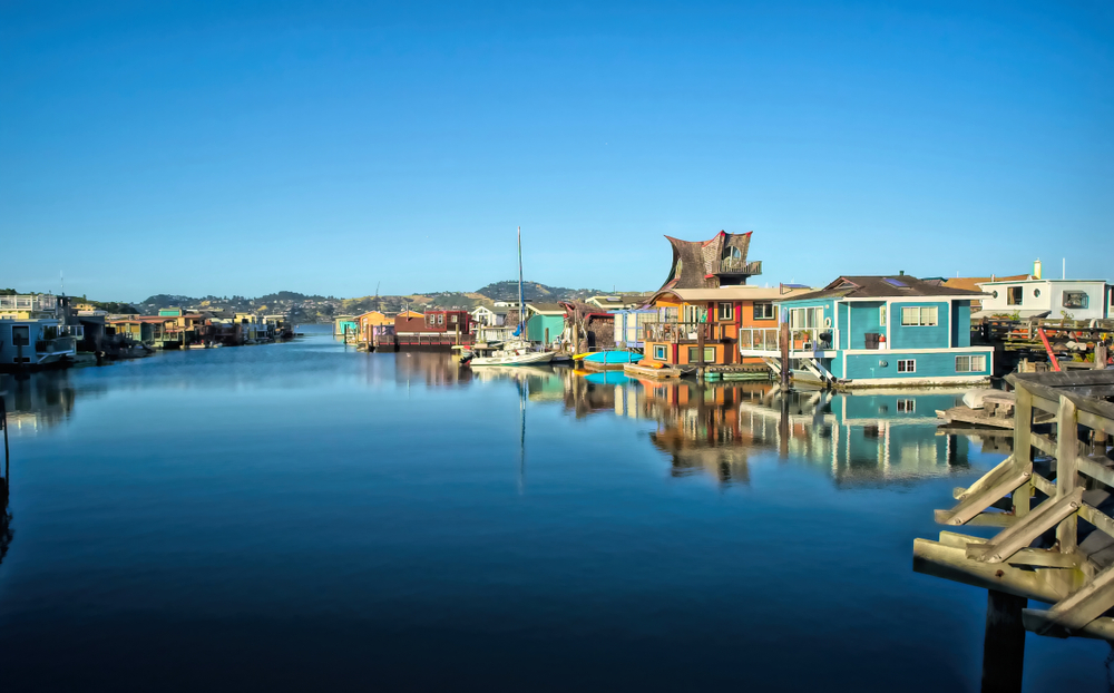 Colorful house boats docked in a marina in Sausalito California best small beach towns in the usa