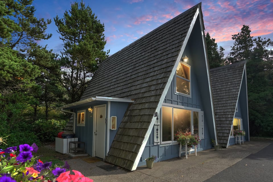 The exterior an A-frame cabin that has been decorated with mid-century design inside that is right near the beach on the Oregon Coast