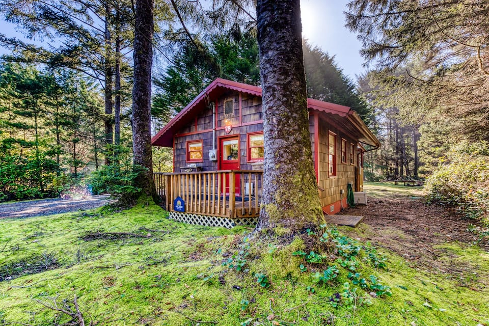 A charming cottage in the woods on the Oregon Coast near the beach, surrounded by trees