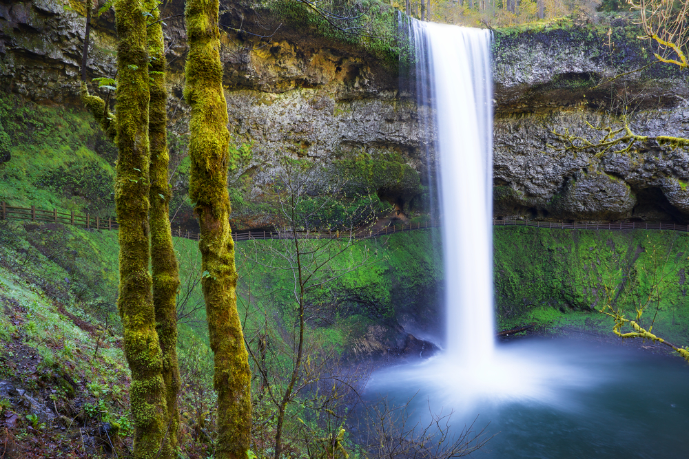 View of South Falls, the tallest waterfall on the Trail of Ten Falls. You can see in the photo that the trail goes right behind the massive waterfall. This is one of the best hikes in Oregon.