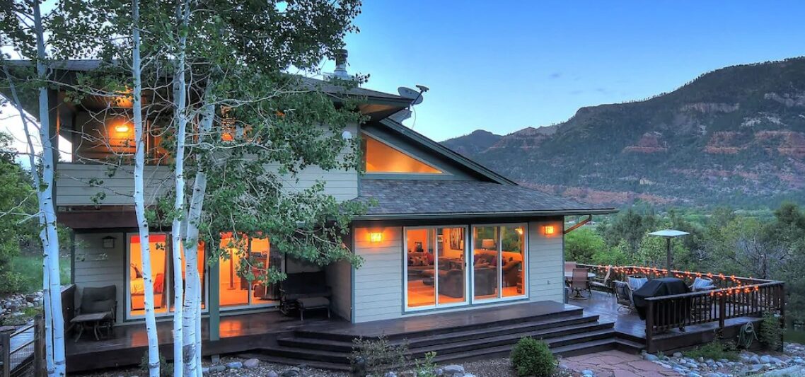 a modern mountain home at twilight VRBO in Colorado