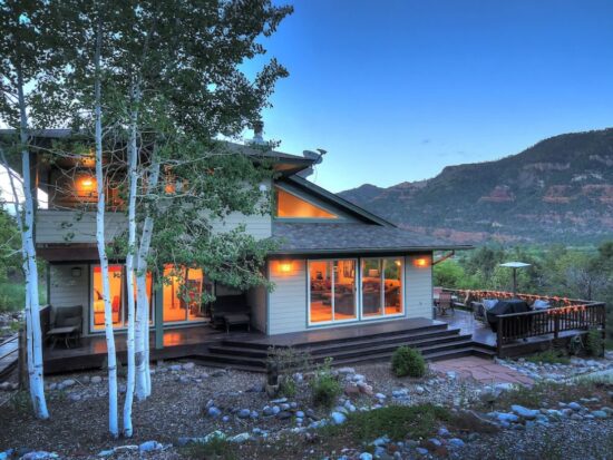 a modern mountain home at twilight VRBO in Colorado