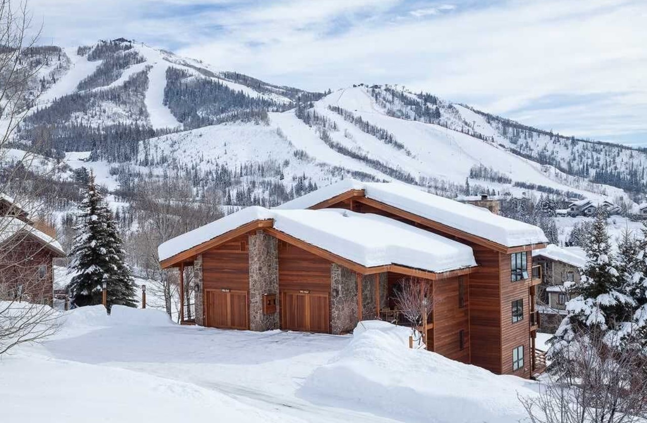 A villa on the side of a hill covered in snow with pretty views of the mountains