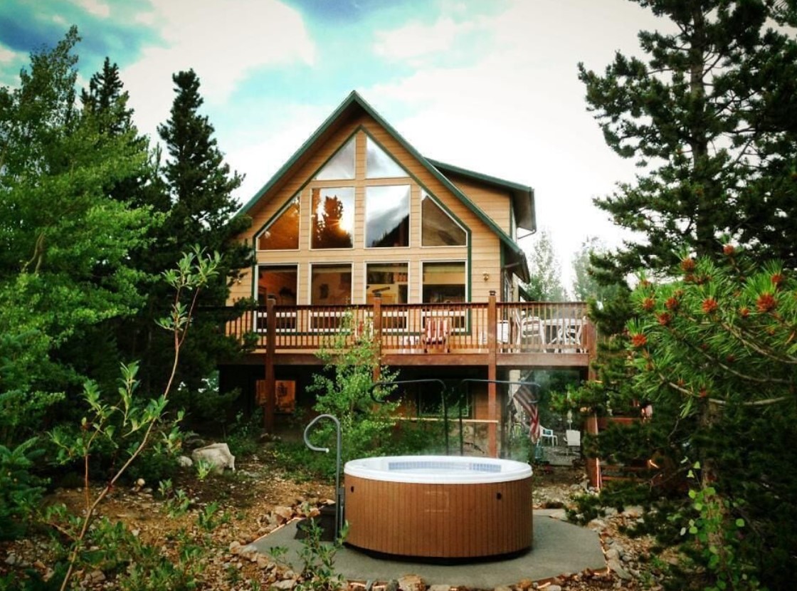 A beautiful A-frame cabin with a large wrap around deck and a hot tub in the yard VRBO in Colorado