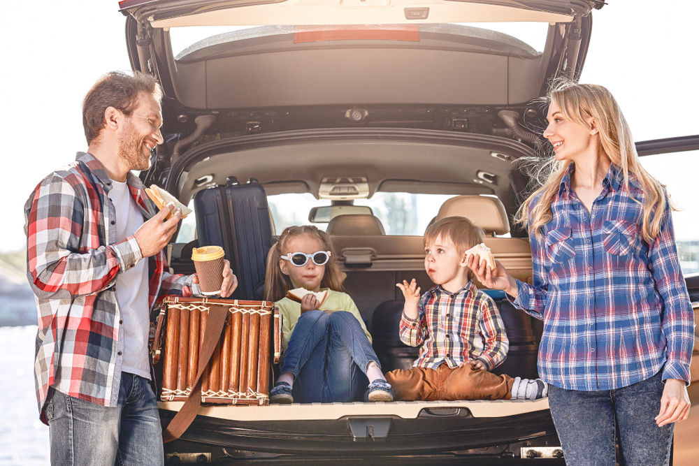 A family enjoying a road trip meal.