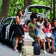 friends hanging out and eating road trip food they packed for their trip