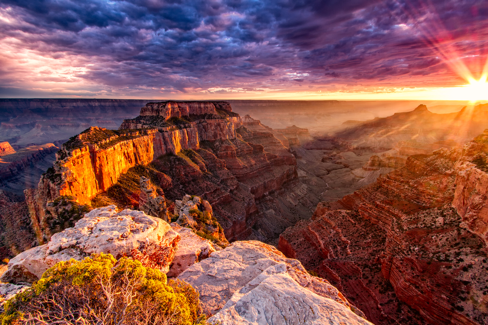 The Grand Canyon at sunset on a cloudy day with pink and purple sky one of the best weekend getaways in the USA