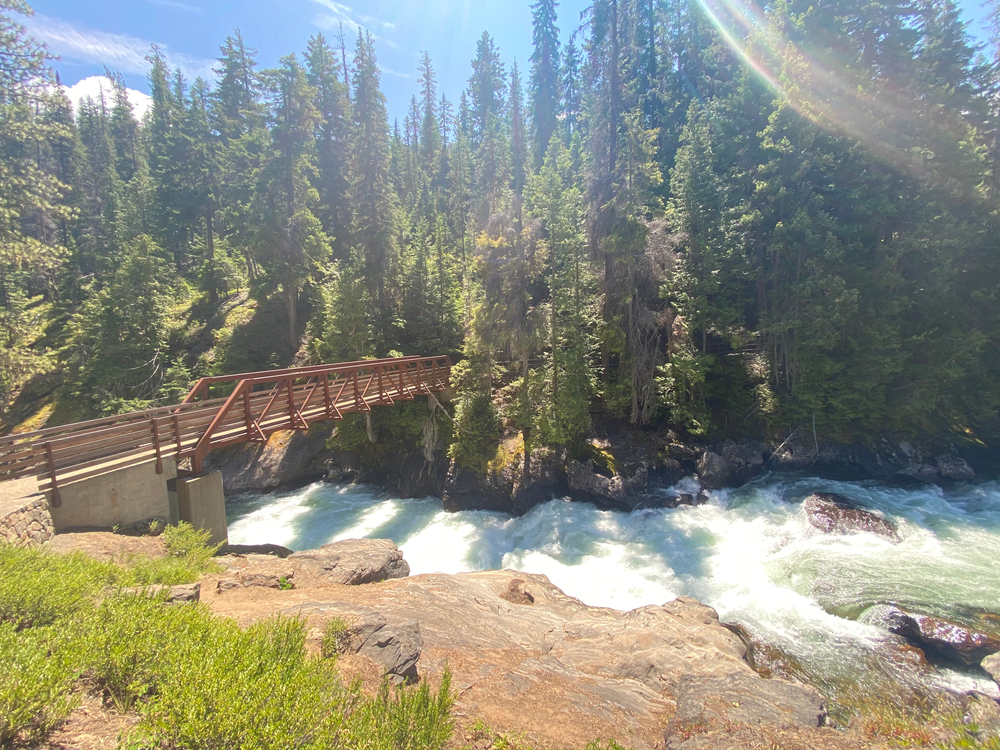 icicle gorge with a rushing stream and bridge crossing over the river