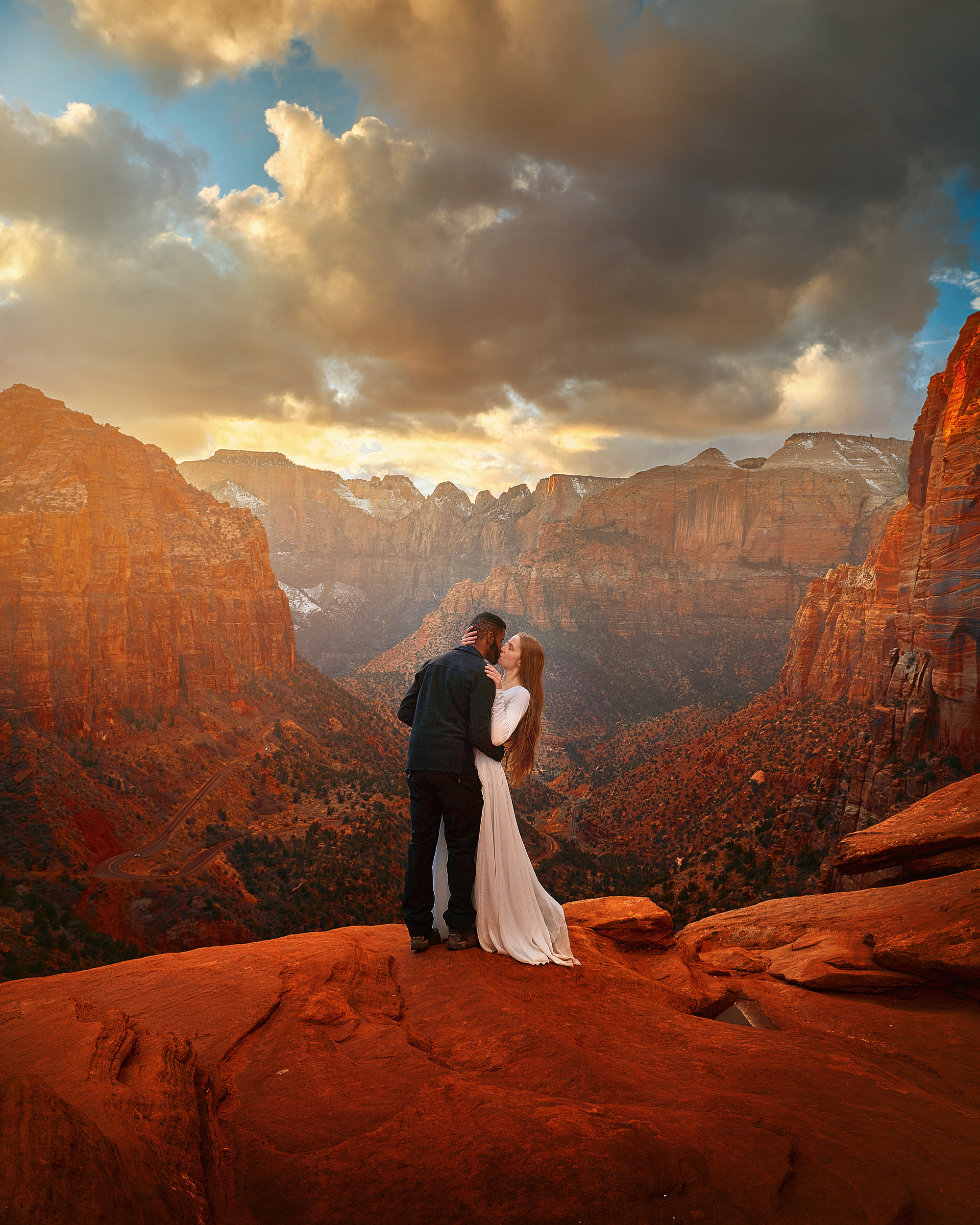 A couple kissing on the side of a cliff at Zion National Park