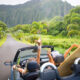 women in car in Hawaii with surfboards