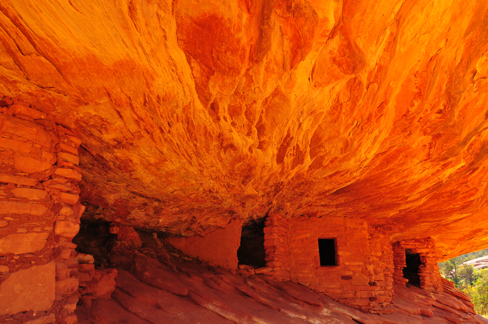 The house on fire ruins which is and underground red sandstone house. The way the rocks are formed over the house make it look like it is on fire.