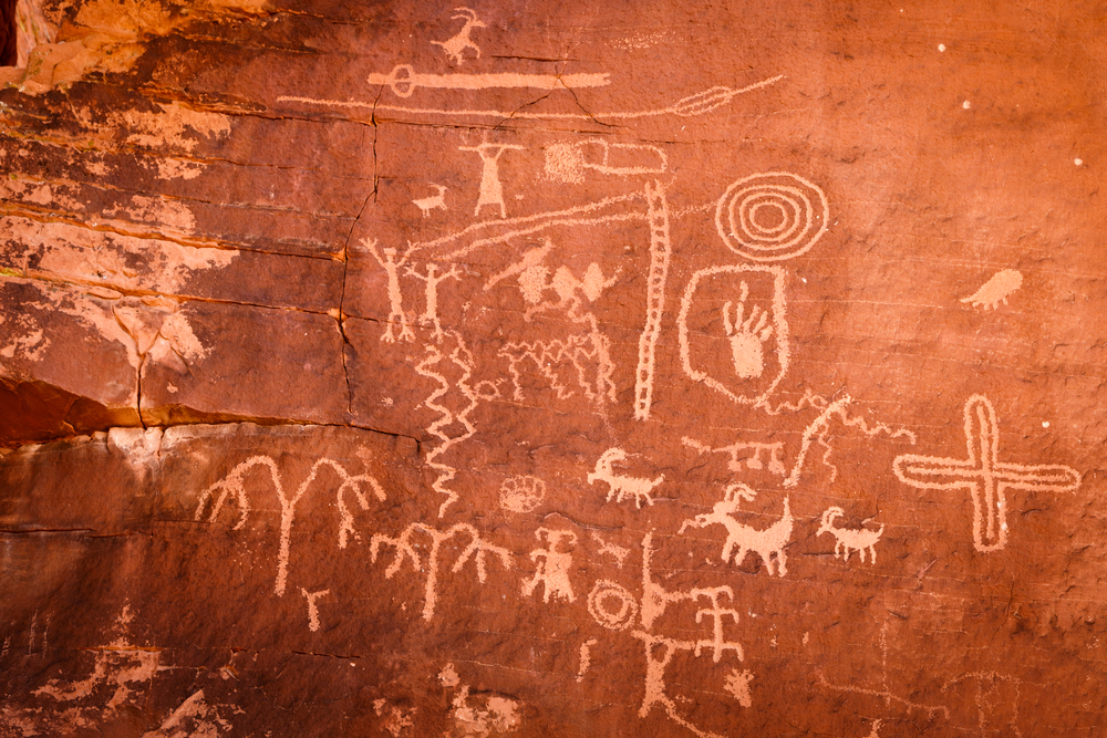 an up close look at the petroglyphs carved into Atlatl Rock including the image of an atlatl