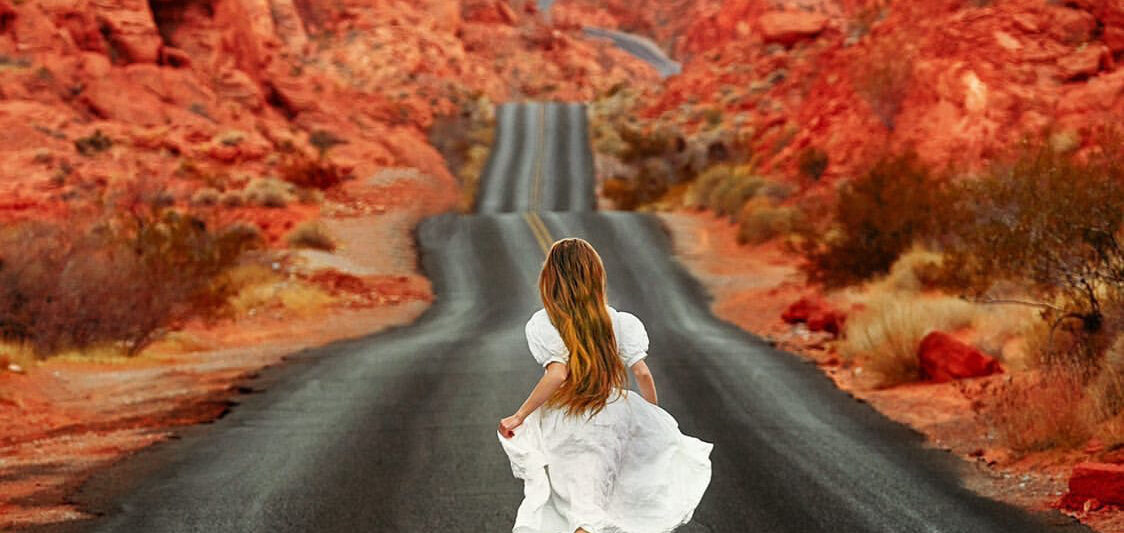 woman running away down street on mouse's tank road in valley of fire state park