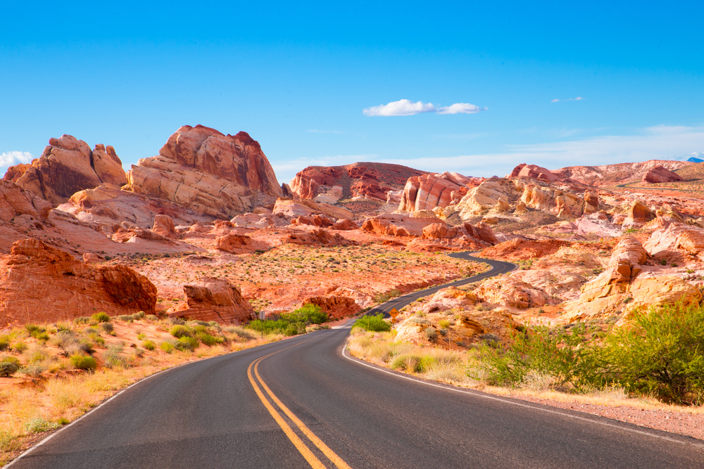 driving through Valley of Fire State Park past the colorful rock formations to reach the main attractions