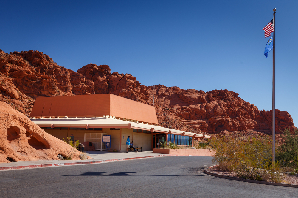 the Valley of Fire State Park Visitor Center with red rock formations behind it