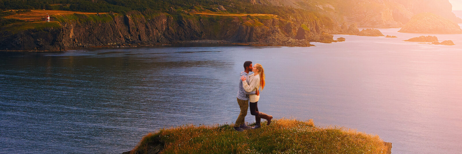 couple kissing on west newfoundland itinerary at sunset