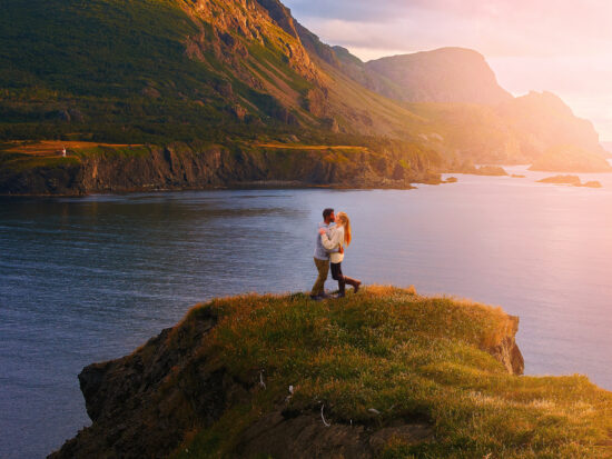 couple kissing on west newfoundland itinerary at sunset